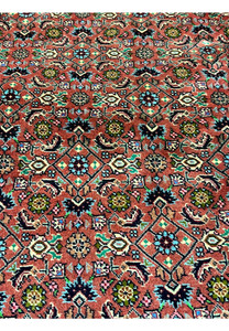 Close-up of Persian Bijar rug motifs featuring stylized flowers, diamond shapes, and classic craftsmanship