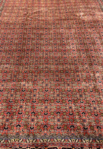 Close-up of Persian Bijar rug midfield highlighting tight wool knots and repeating diamond floral motifs