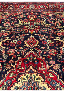 Upper section Persian Mahal rug with floral vines corner spandrels navy field and layered red borders