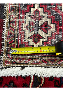 Backside with measuring tape across knots to show pile density and construction quality of 6'4 x 10'1 Persian Heriz hand knotted wool tribal rug
