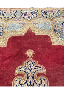 Upper section of Persian Kerman rug with ivory and navy floral border, sky blue cartouches and detailed vine motifs on wool foundation