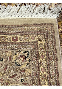 Backside view of hand knotted Agra rug displaying tight knot structure, natural wool foundation, fringe, and authentic handmade craftsmanship
