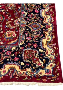 Border detail showing layered guard borders, floral scrollwork, and classic Mashad design structure in rich contrasting tones