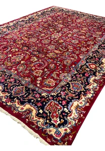 Angled perspective of Persian Mashad rug revealing pile height, color saturation, and dimensional floral patterning