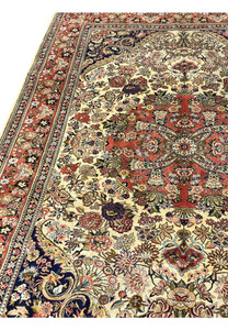 Side angle of premium Persian Bijar rug showing dense pile compact structure and rich coral and navy color contrast