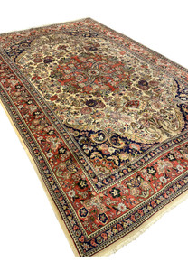 7x10 Persian Bijar rug angled view showing ivory field coral medallion navy spandrels and dense floral border