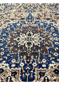 Close up of navy geometric medallion on ivory background vintage Persian Heriz rug with rich wool texture and tribal detailing
