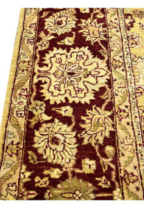 Detailed border closeup of 9x12 gold Agra rug highlighting floral vines and wool texture