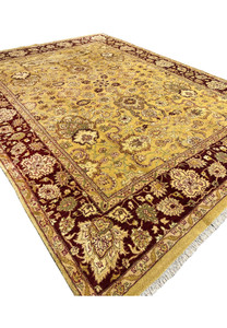 Angled perspective of 9x12 antique gold Agra rug with deep burgundy border and dense floral field