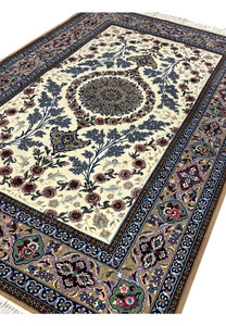 Angled view 5x8 Persian Isfahan wool silk rug ivory field blue medallion taupe border hand knotted Persia