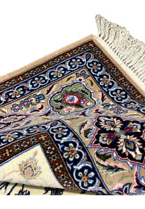 Folded edge detail Persian Isfahan wool silk rug showing hand knotted construction taupe border ivory fringe