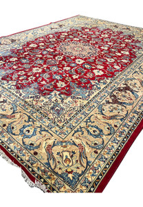 Angled view 10x13 handmade Persian Isfahan wool rug crimson red field ivory animal bird border blue floral scrollwork