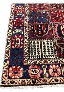 Navy main border with rosette and vine motifs on 7x10 Persian Bakhtiari panel rug