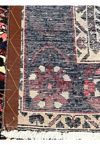 Back side of 7x10 Persian Bakhtiari panel rug showing hand-knotted wool construction