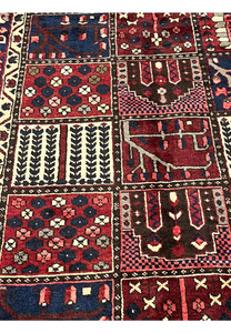 Close-up of hand-knotted khane compartments in 6'8x10 Persian Bakhtiari red and navy rug