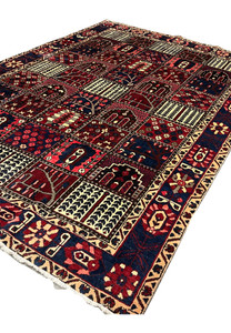 Angled view of 7x10 Persian Bakhtiari panel rug showing wool pile depth and texture