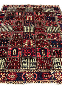 Center field view of 7x10 Persian Bakhtiari rug with garden panel motifs in red and navy