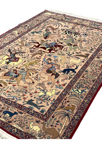 Angled view of 5x8 fine Persian Isfahan Seirafian hunting rug showing silk pile depth and sheen