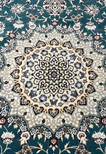 Close-up of ivory star medallion on 7x10 Persian Nain 6La Habibian teal and ivory rug