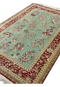 3x5 Persian Qum pure silk rug signed Motevasel garden floral celadon green crimson red angled view