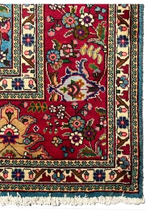 Border edge closeup of 10x13 Persian Tabriz rug, crimson red vine border with ivory guard stripes