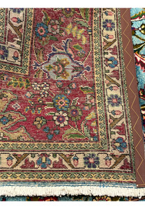 Backside of 10x13 Persian Tabriz rug showing tight hand-knotted weave and cotton foundation