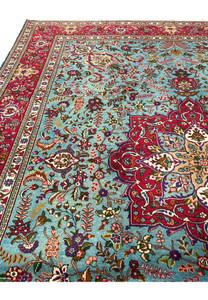 Field view of 10x13 Persian Tabriz rug, sky blue ground with floral bouquets and curling vines
