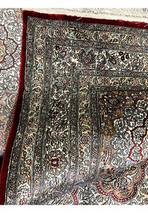 Folded edge revealing the flexibility and luxurious hand of this pure silk on silk rug