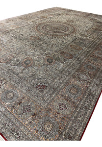 Long side profile of this 12x18 Hereke design rug with silvery ivory field and fine silk fringe