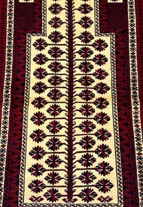 Ivory mihrab field of Baluch prayer rug showing tree of life with geometric star blossoms in red and black