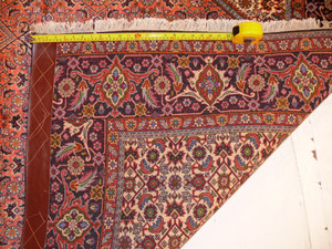 Folded Persian Bijar rug illustrating wool thickness, knot tightness, and plush hand-woven texture.