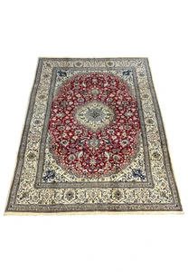Top view of red Persian Nain 9LA rug with ivory central medallion, navy floral details, and balanced symmetrical layout