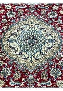 Close-up of Persian Nain medallion showing intricate floral geometry, silk highlights, and fine knot clarity