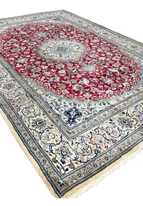 Angled perspective of red Persian Nain 9LA rug highlighting medallion depth, border framing, and surface texture