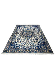 Laid-down 2'11" x 4'6" Persian Nain rug showing intricate floral motifs.