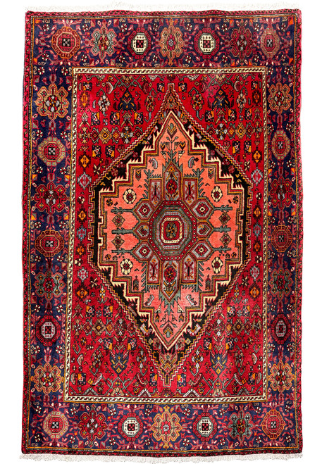 Full view of a 4x6 Persian Gholtogh rug with red central medallion on a navy background