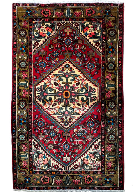 Intricately patterned 3'3 x 5'2 Persian Hamedan rug with a dominant red field and a central floral medallion."