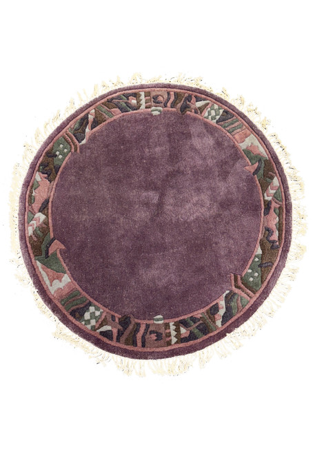 4'8 x 4'8 handmade round Nepalese rug with plum center, muted rose, olive green, and deep brown border, and cream fringes.