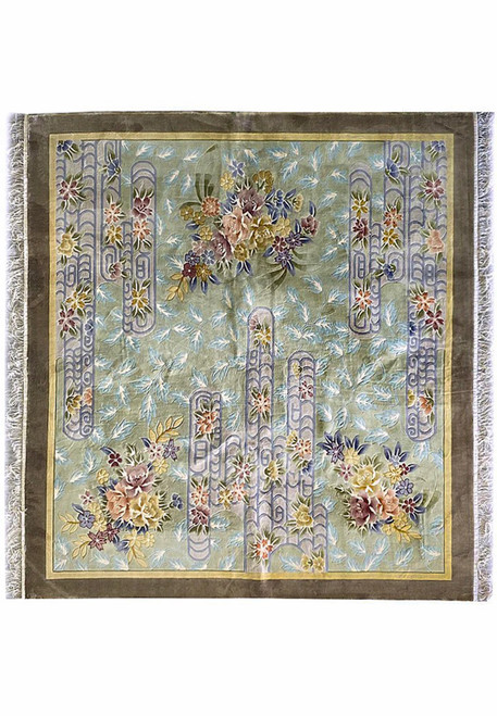 Full view of the 8x8 Vintage Oriental Art Deco Square Rug showing its sage green background, pastel blue scrollwork, and multi-colored floral bouquets hand-knotted in wool with taupe border and ivory fringe.