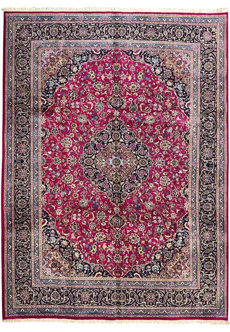 Full laid-down view of 9'9 x 12'8 semi-antique Persian Mashad red wool rug with navy border and central medallion.