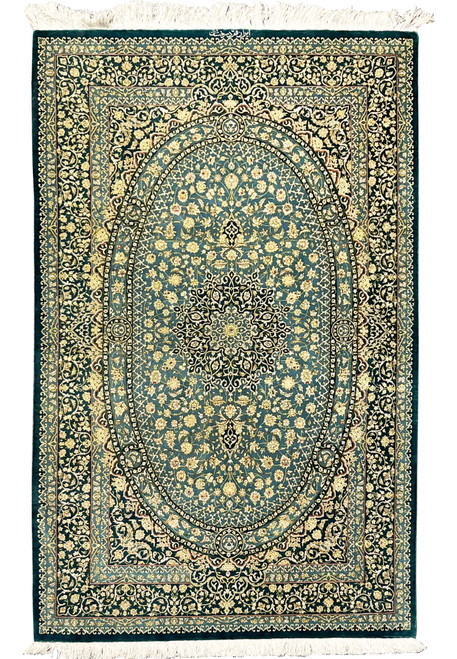Full view Persian Qum pure silk signed Darakhshan rug with oval medallion, teal field and intricate floral border