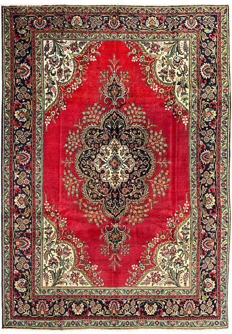 Full overhead view of Persian Kerman rug with crimson field, lobed cartouche medallion, and turquoise minor borders