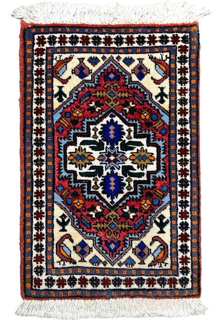 1x2 Persian Ardebil baby rug with an ivory stepped medallion centered on a rust red field