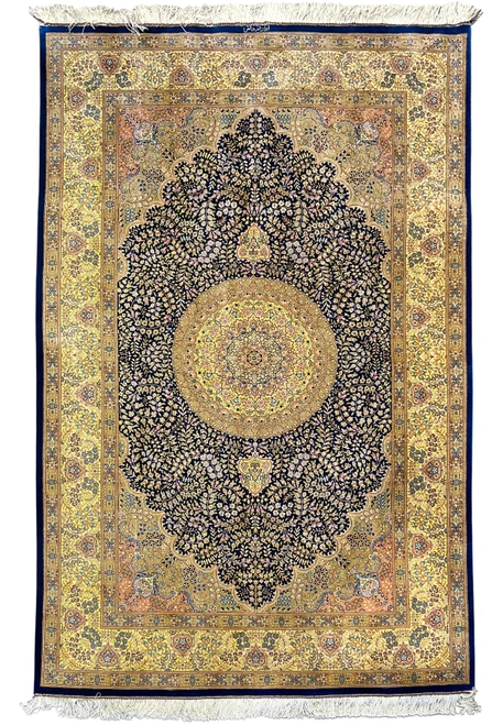 5x8 Persian Qum silk rug shown flat, navy field, gold central medallion, yellow main border