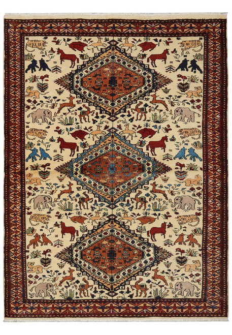 Full overhead view of the ivory Qashkooli rug with three rust diamond medallions and scattered animals