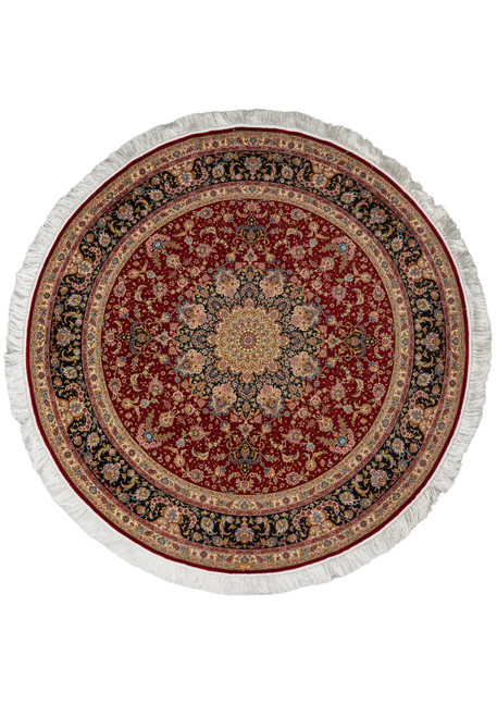 Full round silk rug shown flat, deep red field, ivory centre medallion, navy border, white fringe