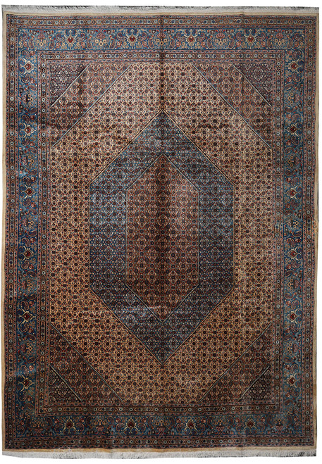 Whole rug seen from above: camel beige field, dark hexagonal medallion, wide blue border, fringed ends
