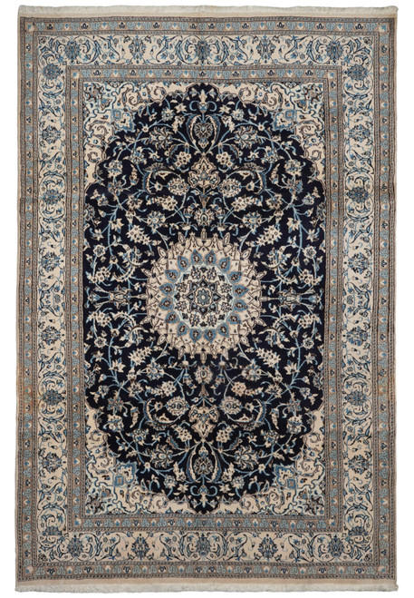 Full overhead view of the navy Nain rug with ivory medallion and wide floral ivory border