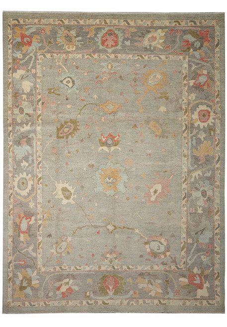 Full overhead view of the grey-sage Oushak rug with wide brown border and ivory guard stripes