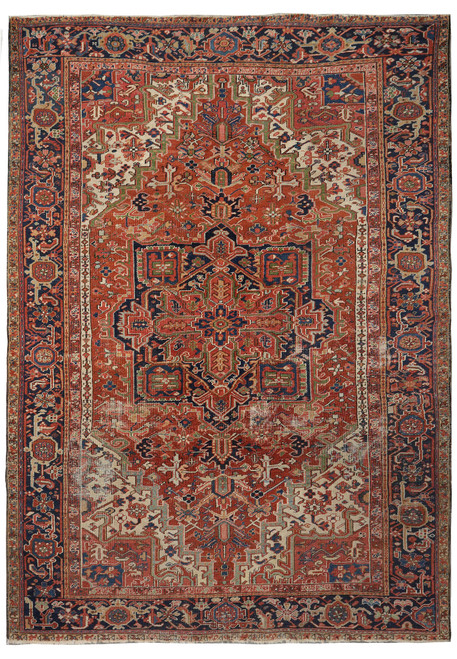 Full overhead view of brick red Heriz rug with navy star medallion and ivory corner spandrels